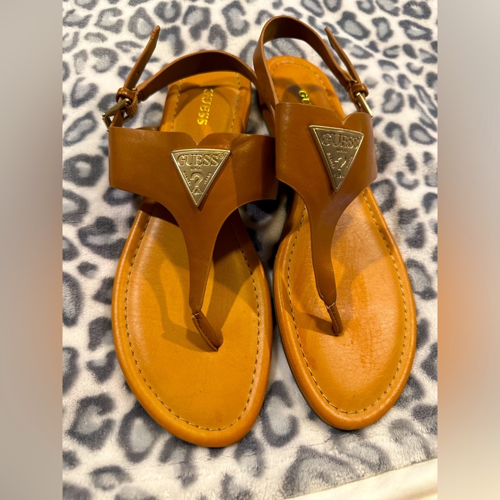 Guess thong type sandal with adjustable back strap.
